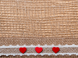 Wall Mural - Red hearts on abstract cloth background