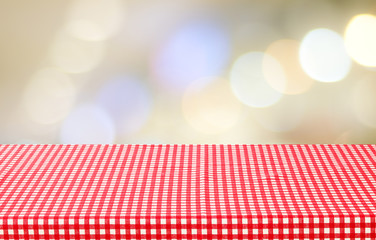 Empty table with tablecloth over blur bokeh background