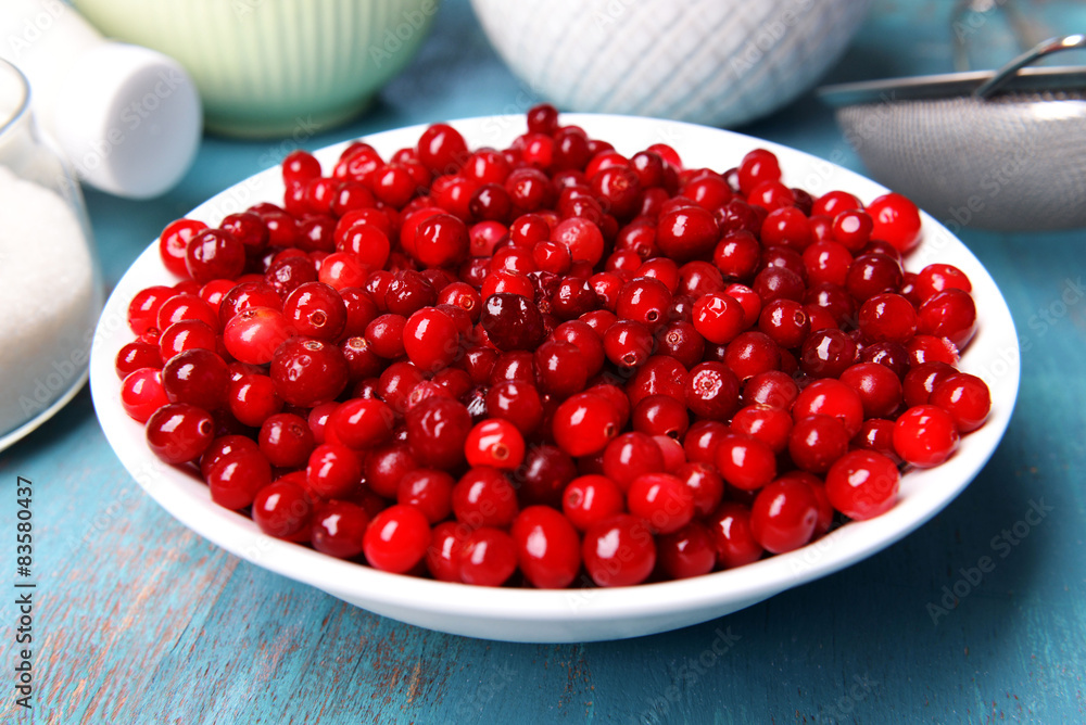 Cranberries in bowl on kitchen table close up