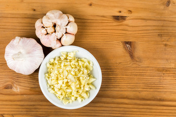 Chopped garlic in a plate with garlic bulb and cloves