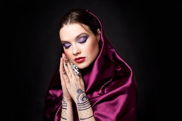 beautiful woman in oriental style with mehendi in hijab