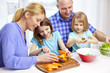 © Syda Productions - happy family with two kids cooking at home