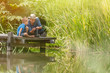 © jackfrog - On a wood pontoon, father teaching his young son to respect nature