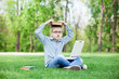 © Masson - young surprised boy with a books and laptop