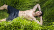 © theartofphoto - Fit muscular shirtless young man relaxing lying in a field