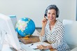 © WavebreakmediaMicro - Smiling travel agent sitting at her desk