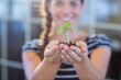 © WavebreakMediaMicro - Brunette holding green sprouts