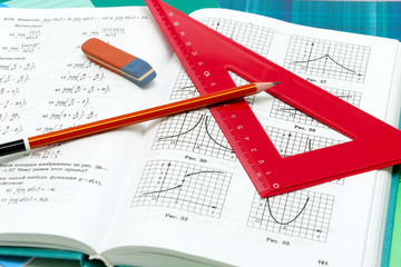 school supplies and textbooks on mathematics close up