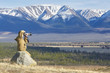 Photographer taking pictures of a mountain chain in Altai