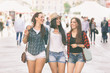 © william87 - Three happy women walking in the city