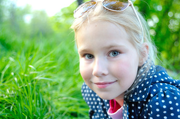 Cute little girl on the meadow in summer day