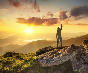 Wall Mural - silhouette of a champion on mountain peak. active life concept
