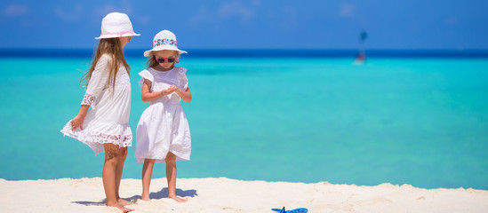 Adorable little girls having fun during beach vacation