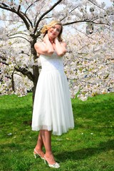 Beautiful female posing in the sakura garden