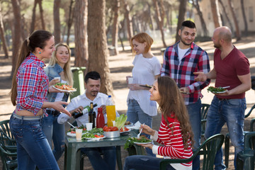 Happy friends making grill .