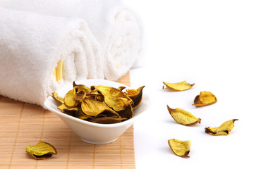 Spa concept. Yellow potpourri and white towels.