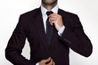 Businessman adjusting his suit and tie