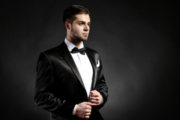 Poster - Elegant man in suit on dark background