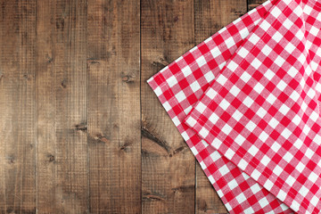 Checkered napkin on wooden table background