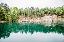 Cloudy Skies And Reflections At A Quarry