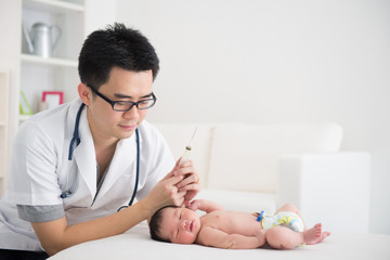 Wall Mural - Good looking asian doctor and newborn baby on the clinic