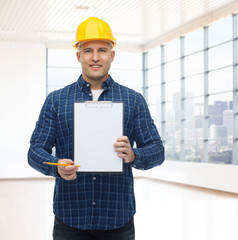 Poster - smiling male builder in helmet with clipboard