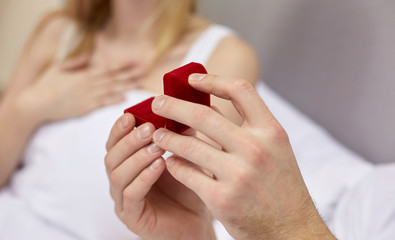 Wall Mural - close up of hands holding little red gift box