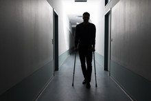Man Walking With Crutches