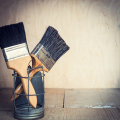 Paint brushes on wooden background, with copy space