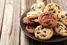 Chocolate Chip Cookies On Plate On Brown Wooden Background
