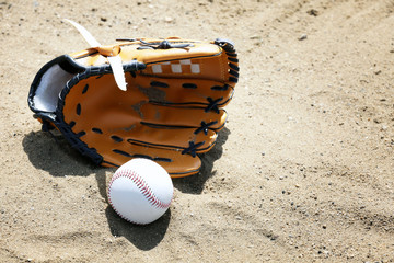 Wall Mural - Baseball ball and glove on sand