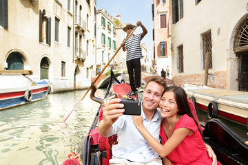 Wall Mural - Travel couple taking selfie in Venice gondola