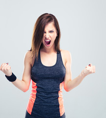 Wall Mural - Angry young fitness woman screaming