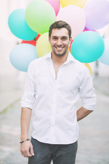 Wall Mural - man with colorful balloons in the city