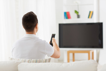 Poster - man watching tv and changing channels at home