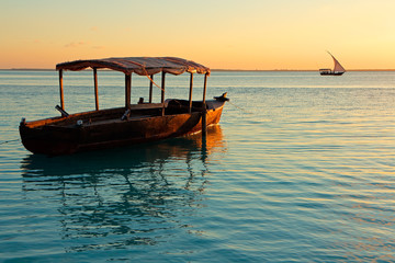 Poster - Wooden boat on water at sunset, Zanzibar island