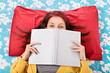 © Mendelex - Girl in bed hiding her face behind a book