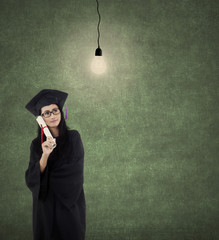 Wall Mural - Graduate student with lightbulb