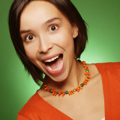 young expression woman over green background