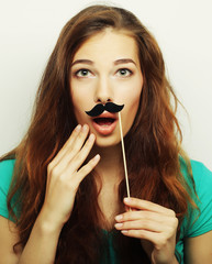 Girl wearing fake mustaches. Ready for party.