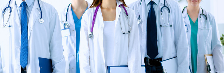 Portrait of group of smiling hospital colleagues standing