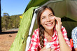 Camping woman applying sunscreen sun cream in tent