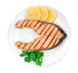 Wall Mural - Grilled salmon steak with vegetables on plate.