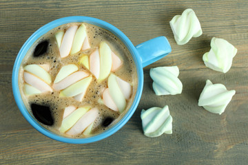 Wall Mural - A cup of hot chocolate with marshmallows on the wooden background