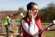 © dglimages - Female construction organiser on the phone with male workers in