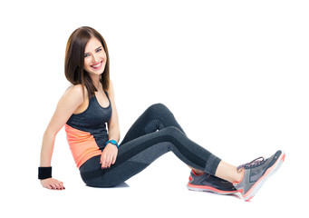 Poster - Cheerful sporty woman sitting on the floor