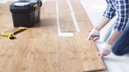 Wall Mural - close up of man installing wood flooring