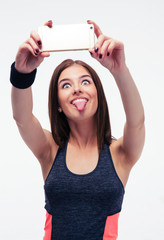 Wall Mural - Sporty woman making selfie photo and showing tongue