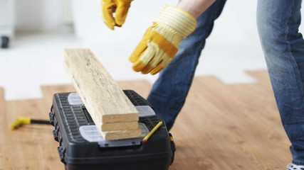 Wall Mural - close up of man hammering nail to wooden board