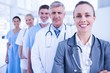 © WavebreakMediaMicro - Smiling team of doctors standing in line
